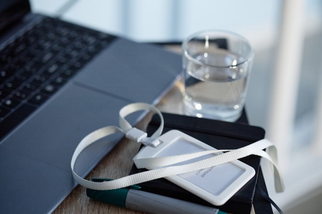 A plastic ID card holder on a desk in an auditorium, one of the most common id card holder types for conferences and events